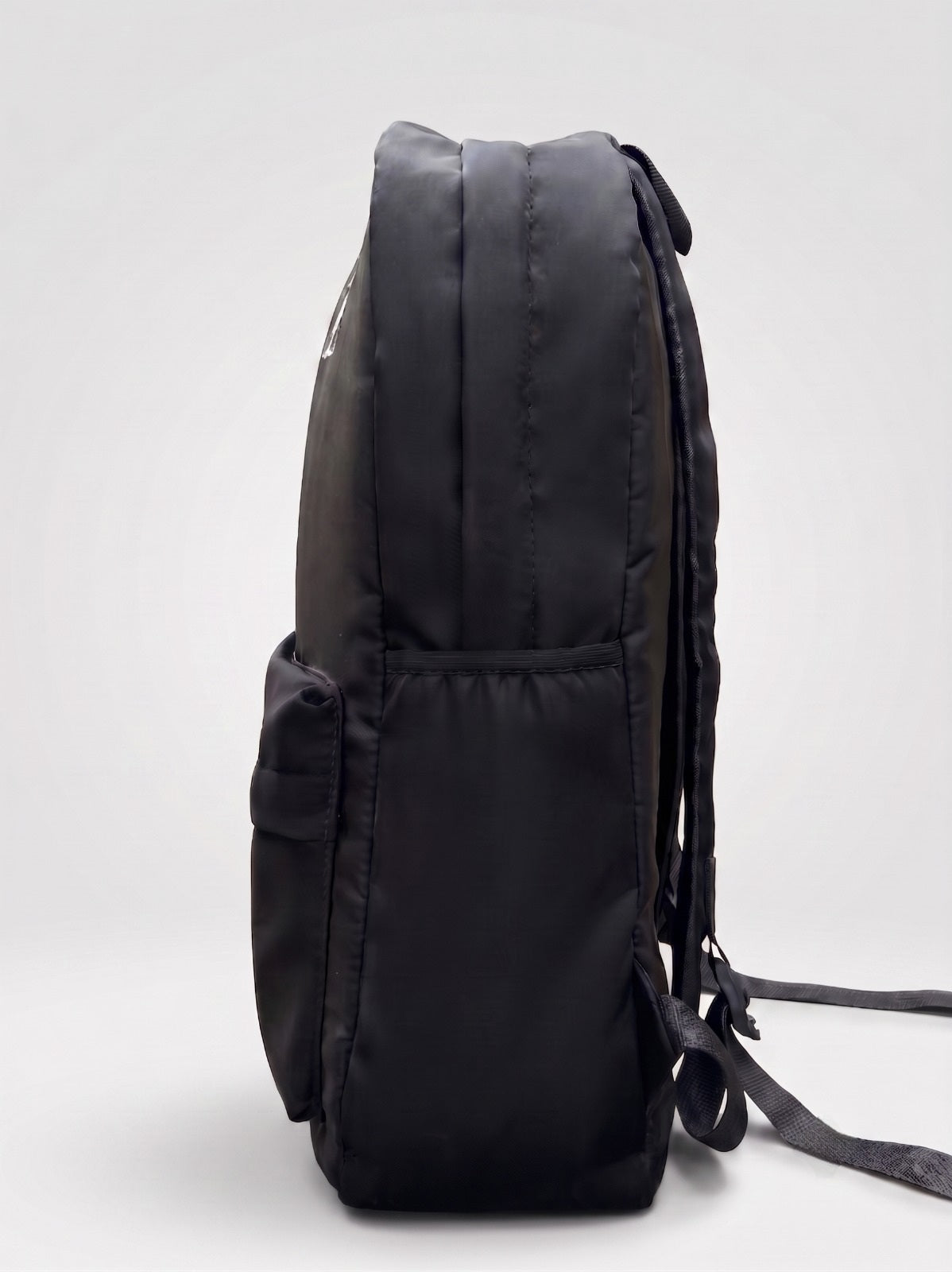 La Haasil black laptop bag side view, slim profile with water bottle pocket